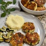 Cheesy Chicken Fritters on a plate with mashed potatoes, zucchini and feta cheese