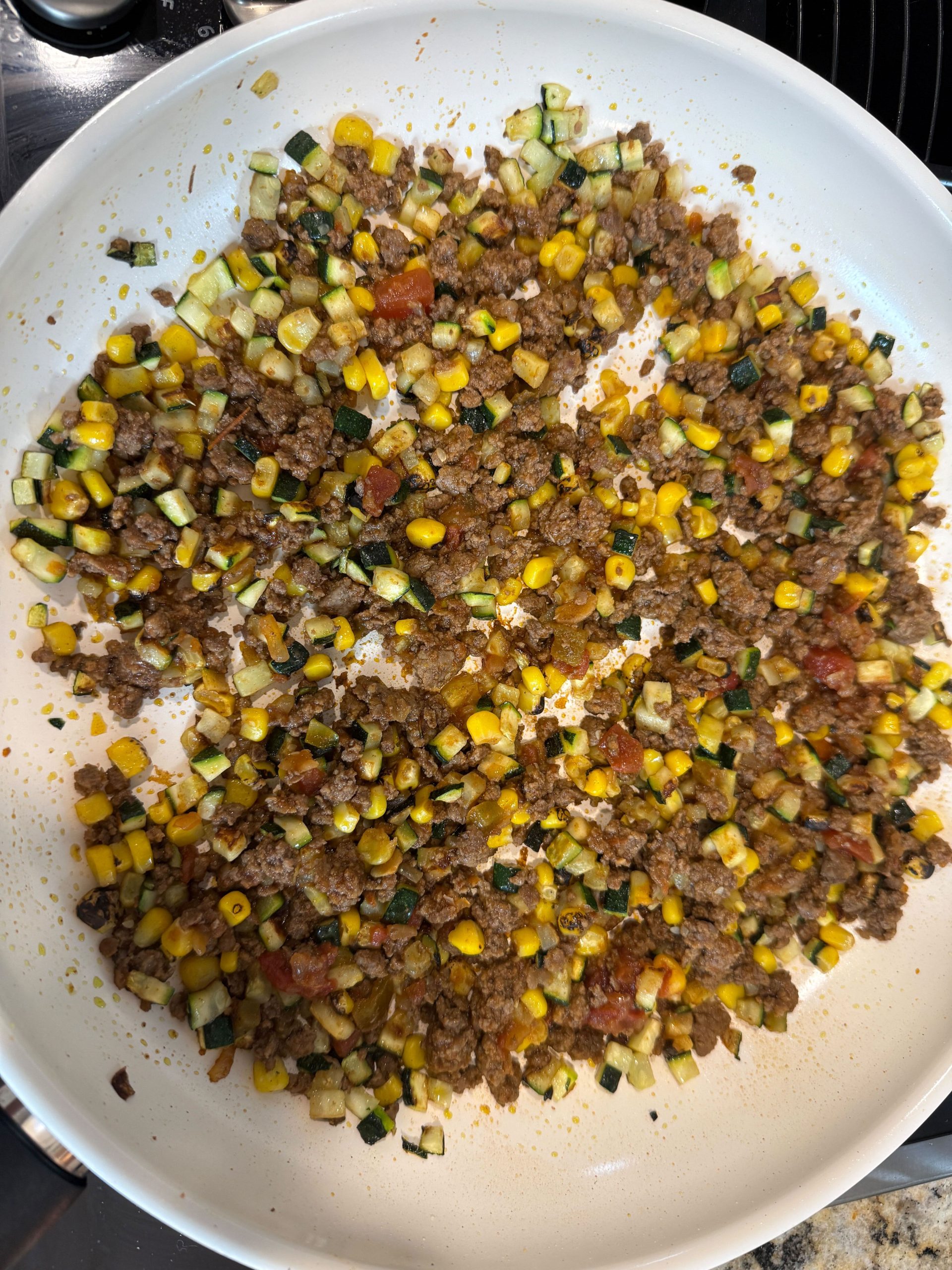 Ground chicken, corn and zucchini in a pan