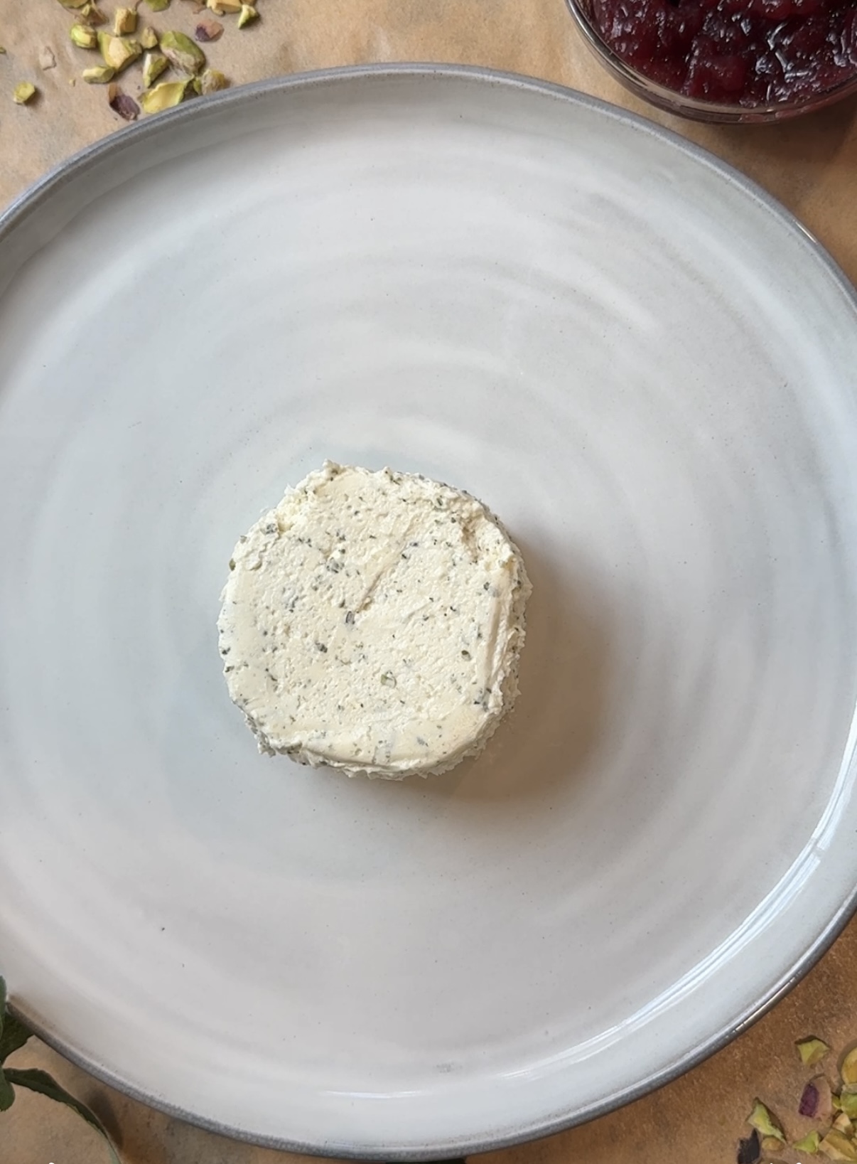 A plate with a block of Boursin cheese on it