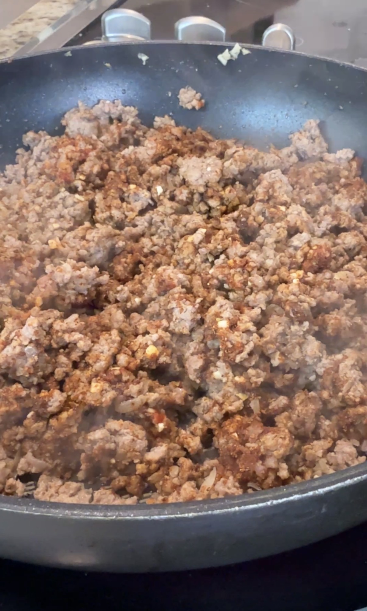 A frying pan with cooked taco ground beef.