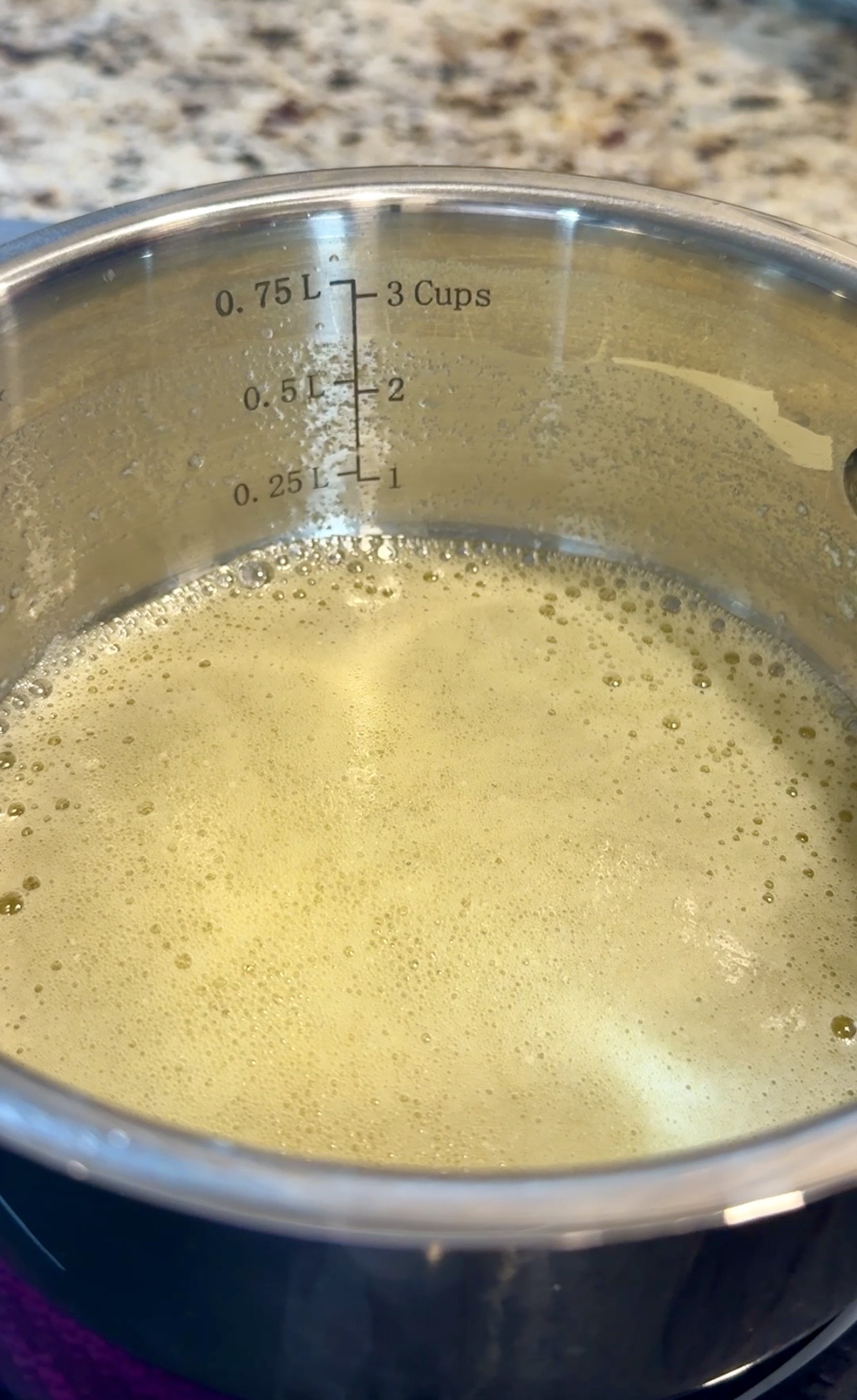 Stainless steel pot with the melted butter.