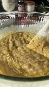 Wet ingredients for the banana muffins in a glass bowl