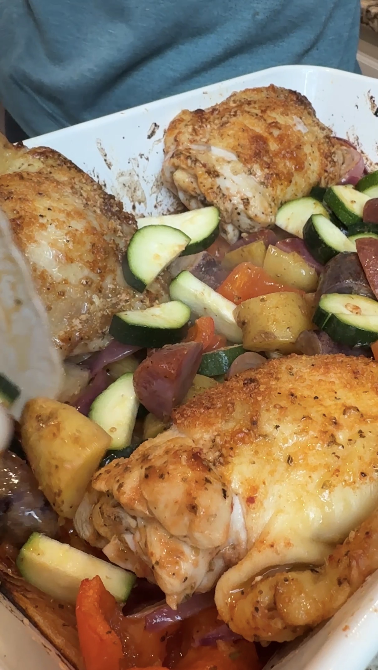 Baking dish with veggies and chicken thighs