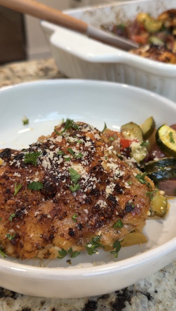 A bowl with chicken thigh and veggies