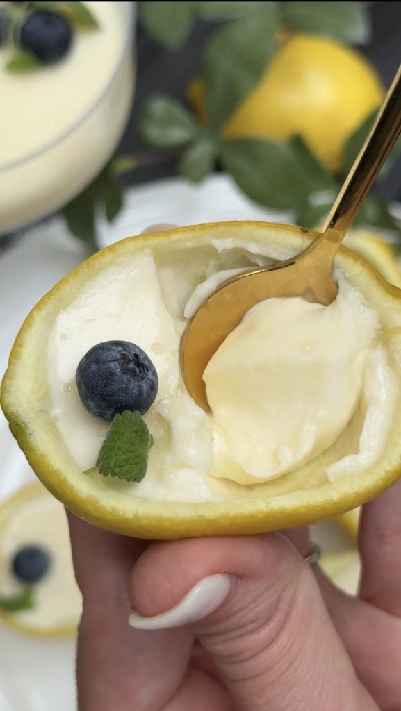 A hand holding lemon posset