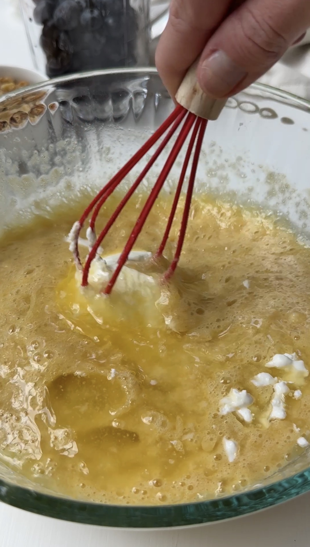 Mixture after yogurt is added being stirred with a whisk.
