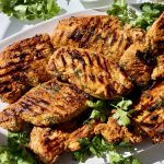 Greek yogurt marinated chicken on a platter.