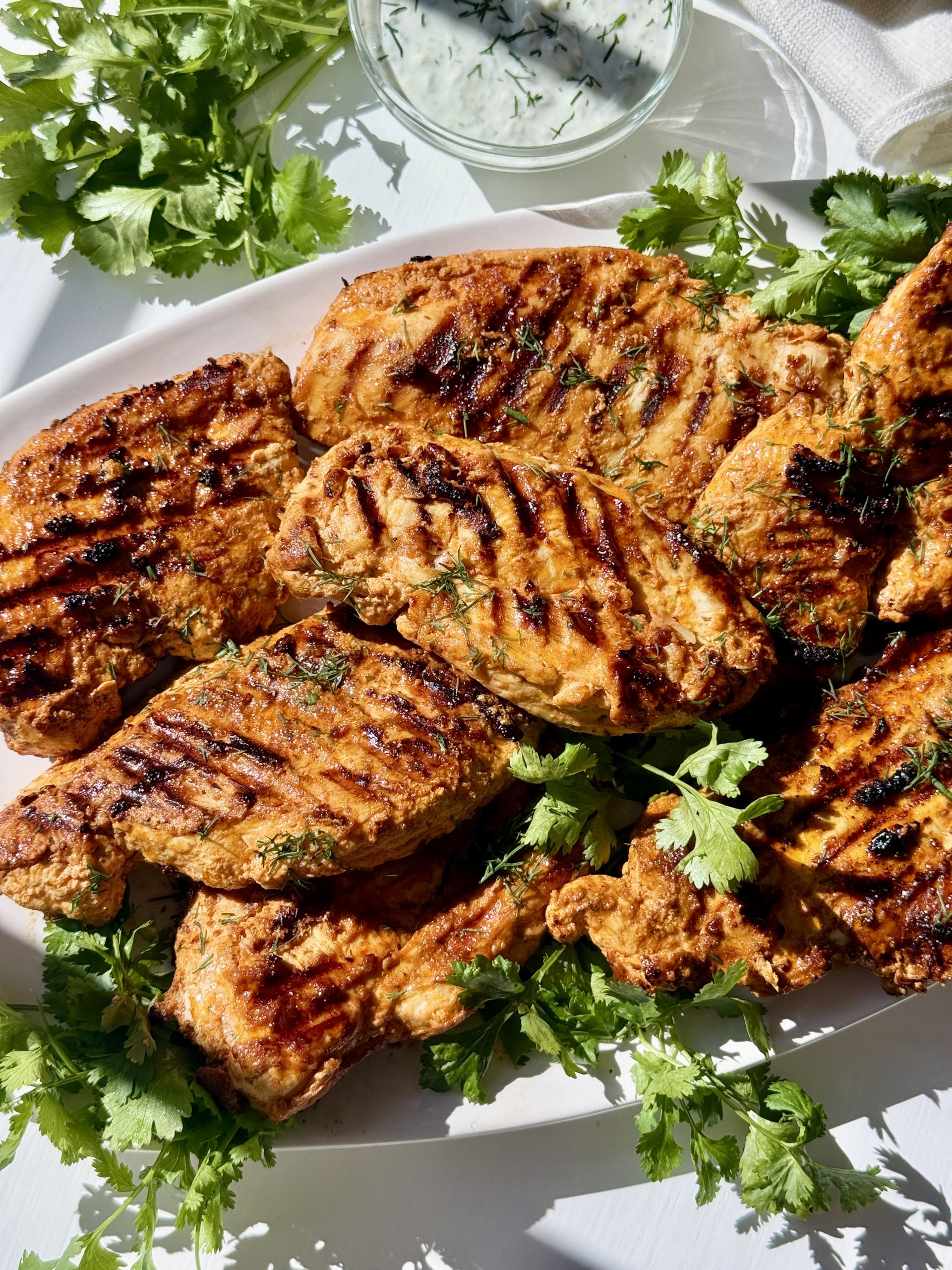 Greek yogurt marinated chicken on a platter.