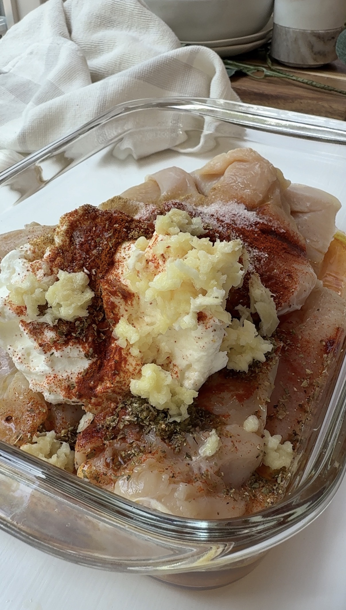 Chicken marinade with Greek yogurt added to a pan of chicken. 