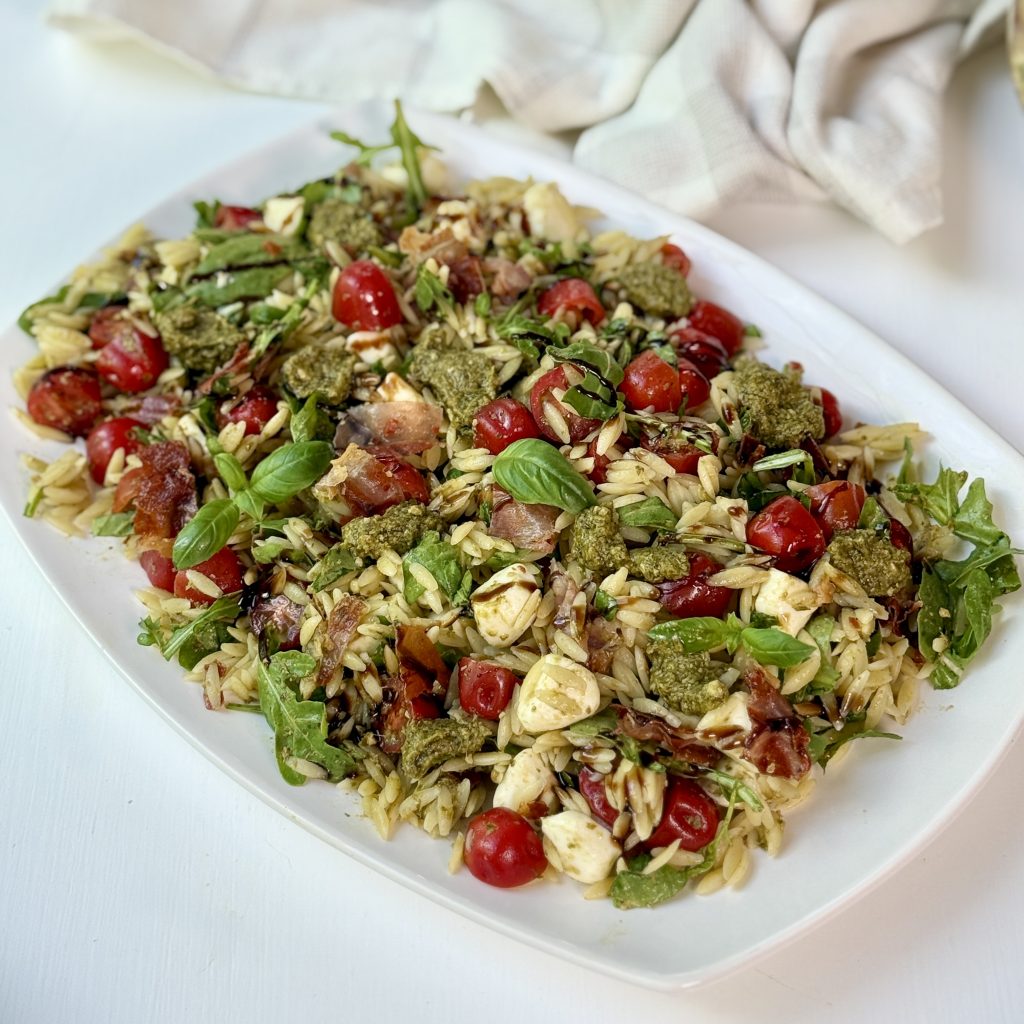 Pesto orzo pasta salad on a white plate.