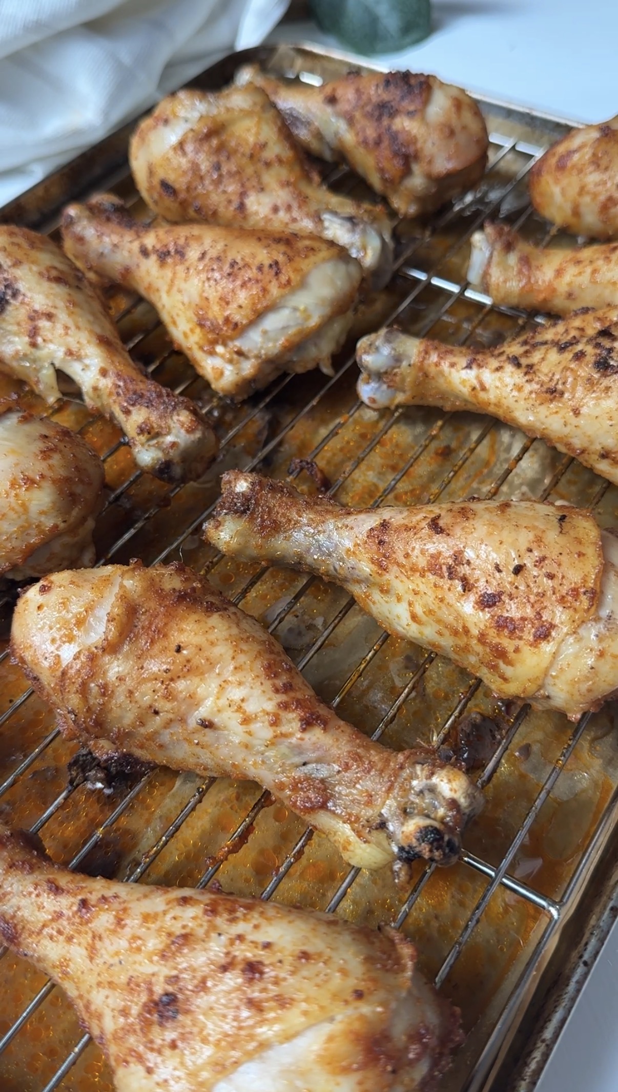 Baked chicken drumsticks on the pan after cooking.