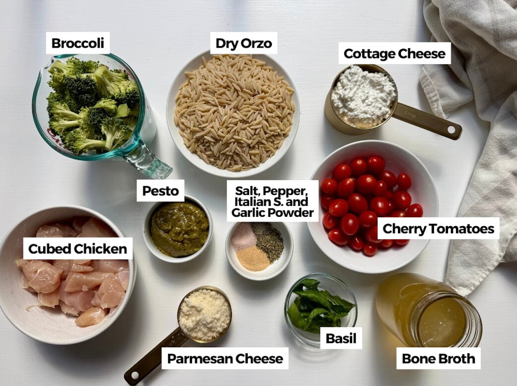 Ingredients to make a pesto chicken orzo bake on a table.