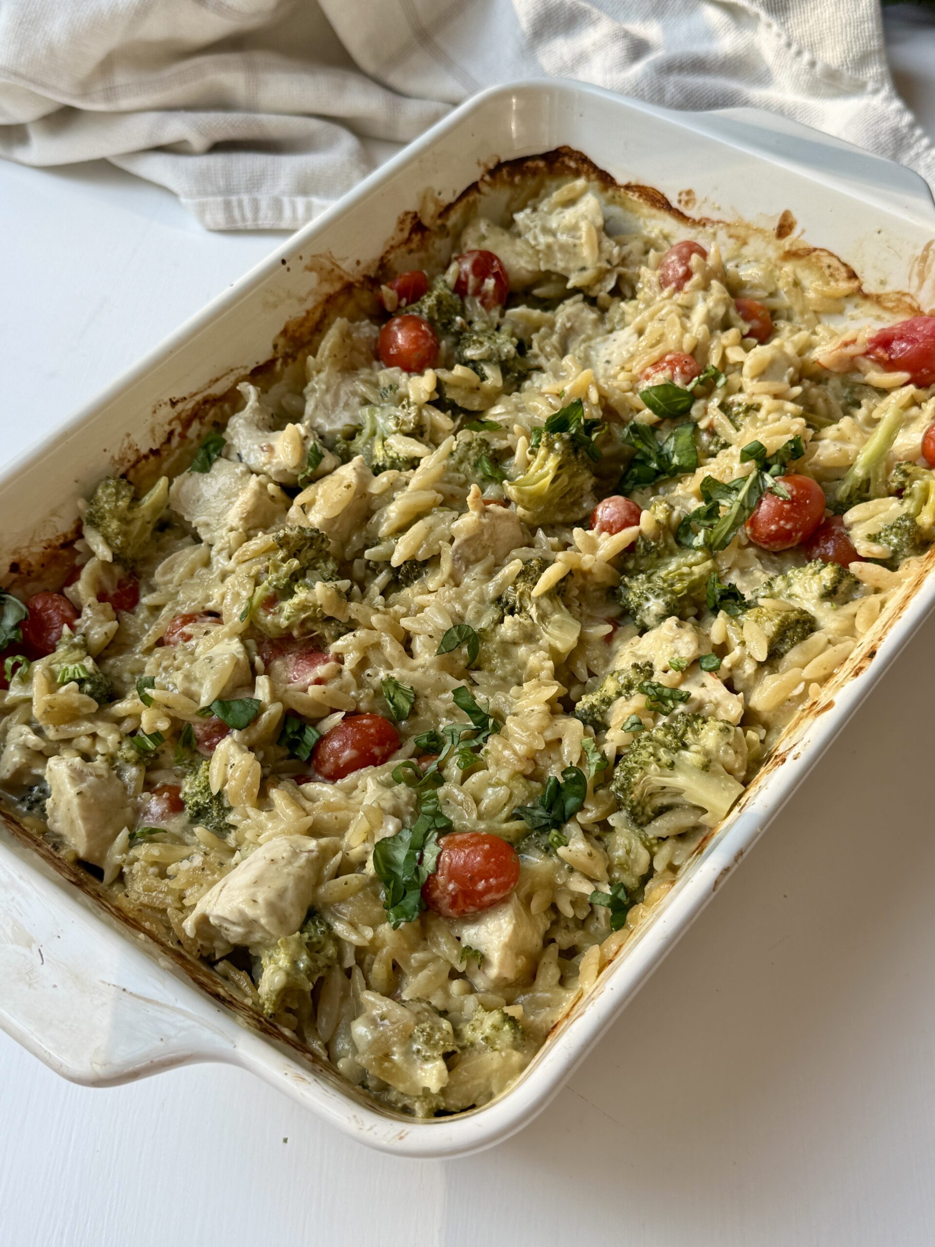 Baked pesto chicken orzo casserole ready to serve.