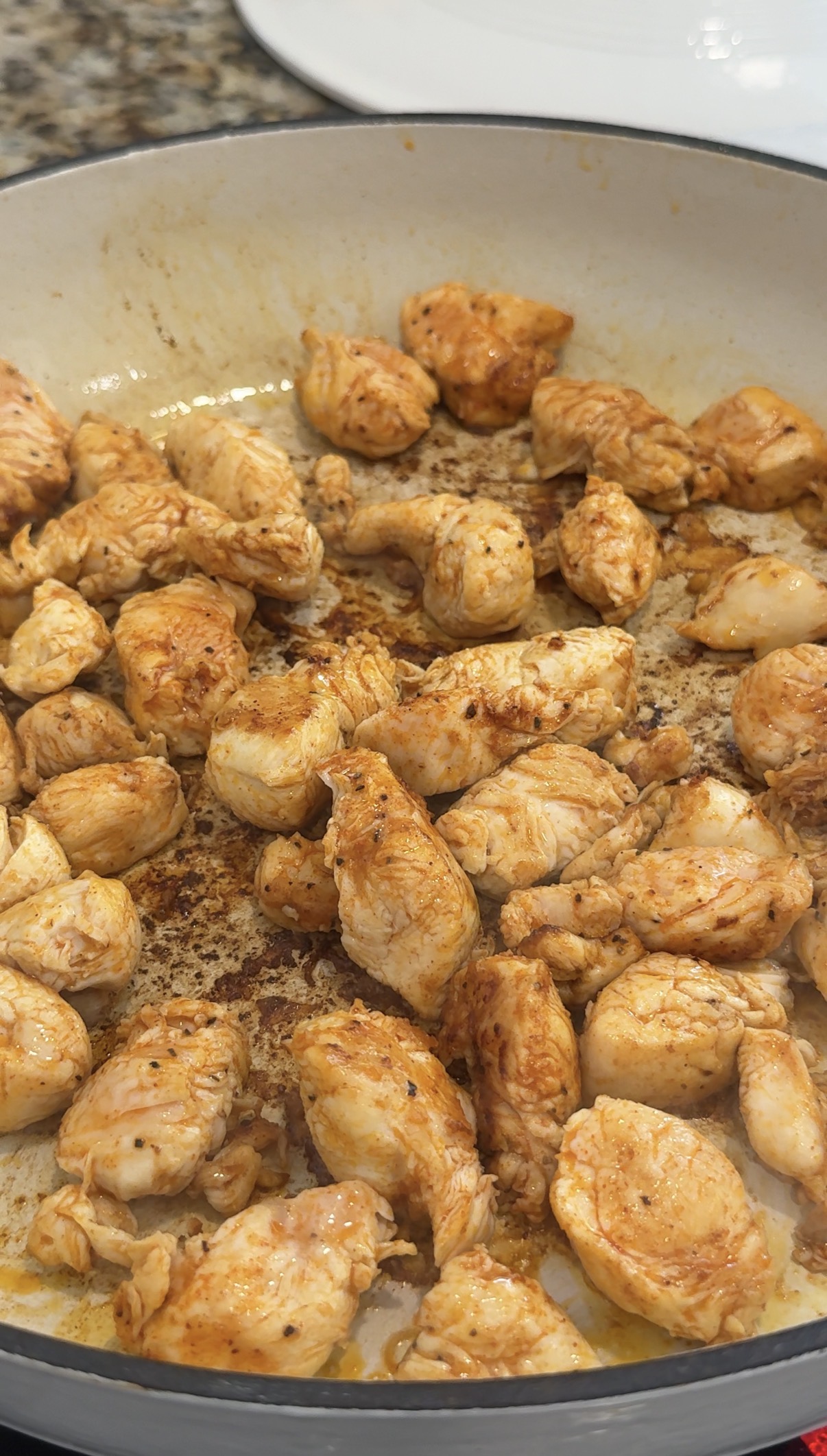 Chicken cooking in a skillet. 