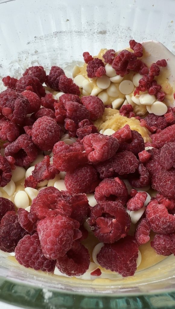 Adding the raspberries to the batter.
