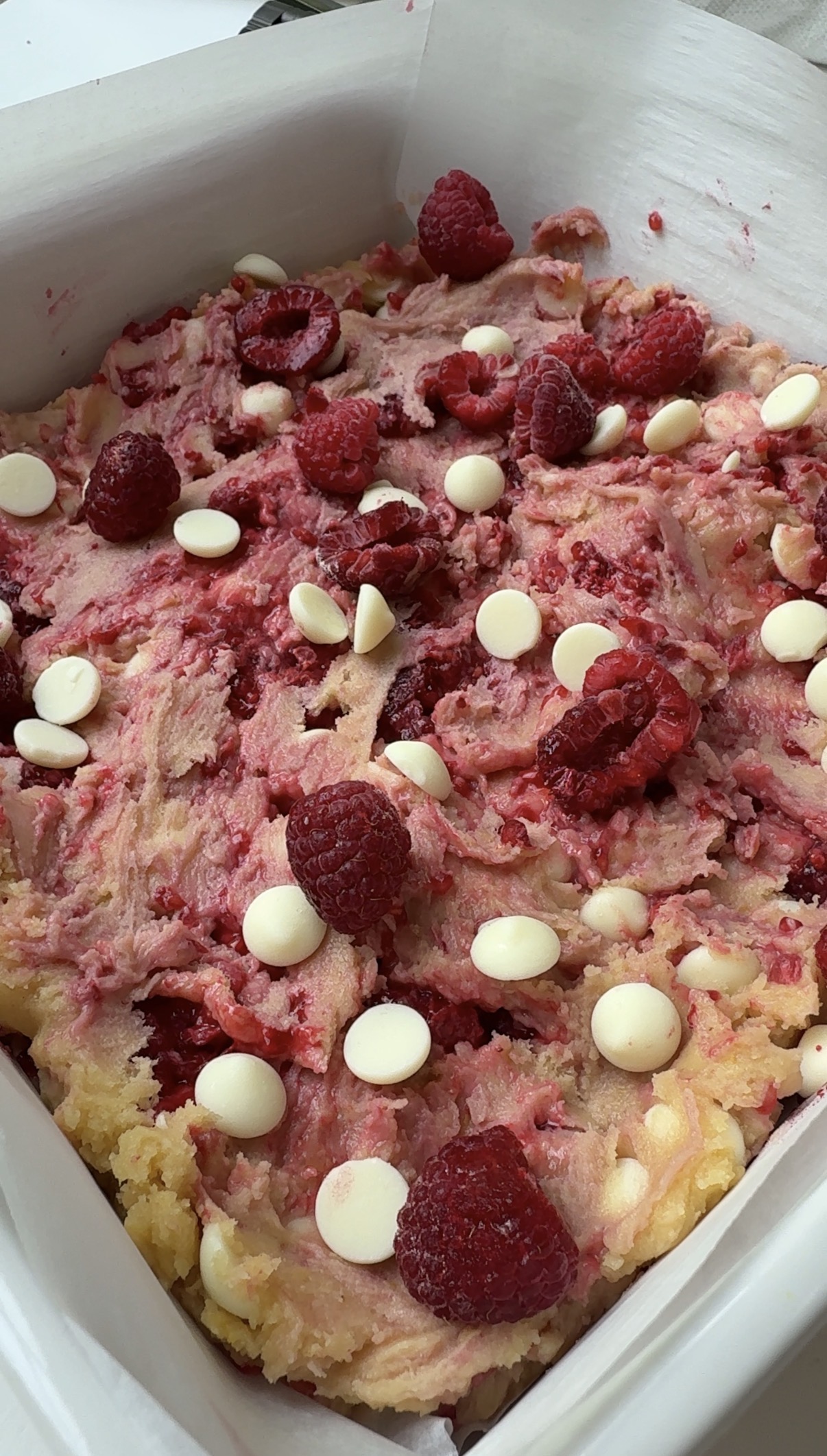 White chocolate raspberry blondie batter spread in a pan.