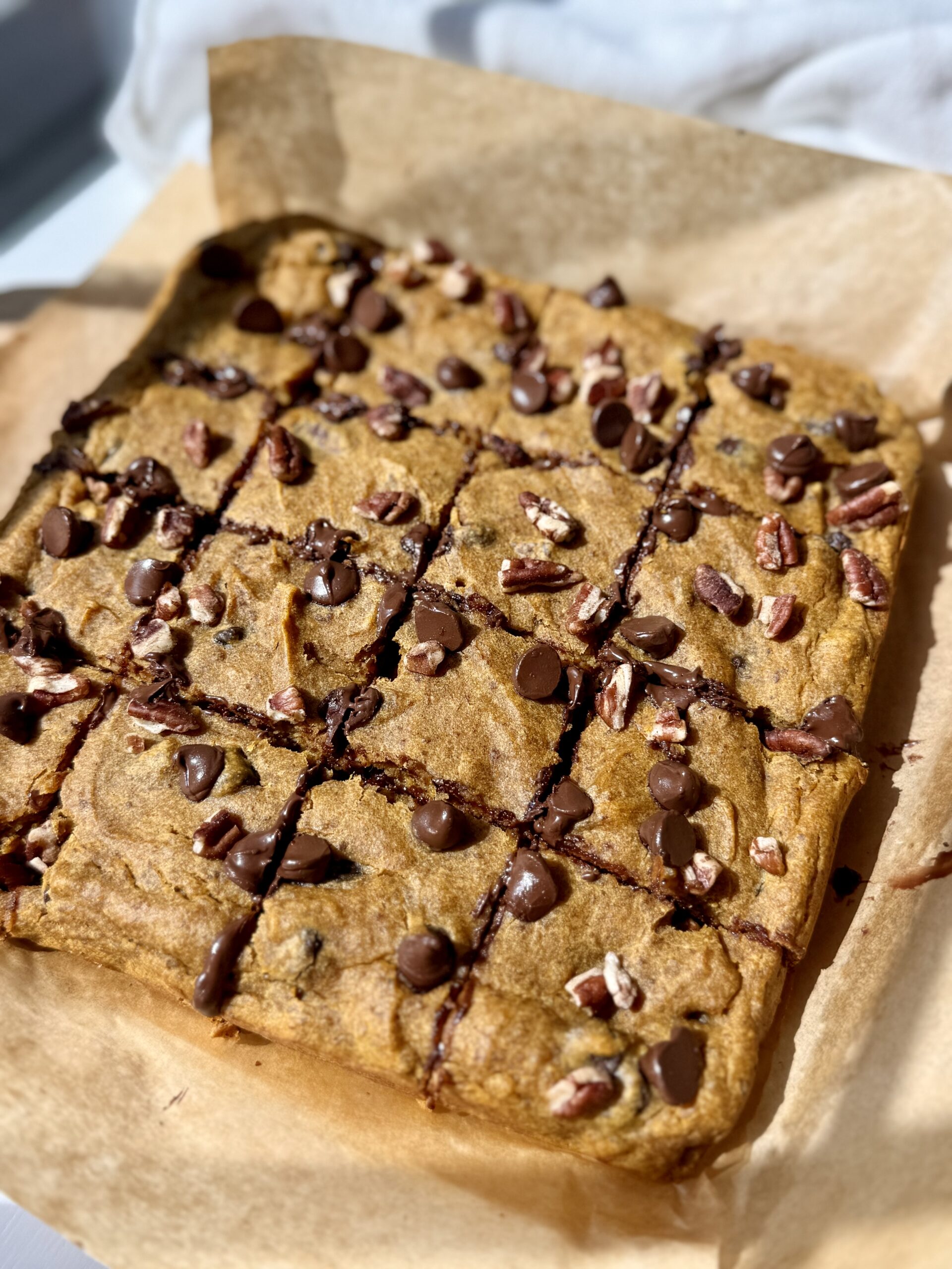 Soft pumpkin bars with chocolate chips and pecans sliced into squares