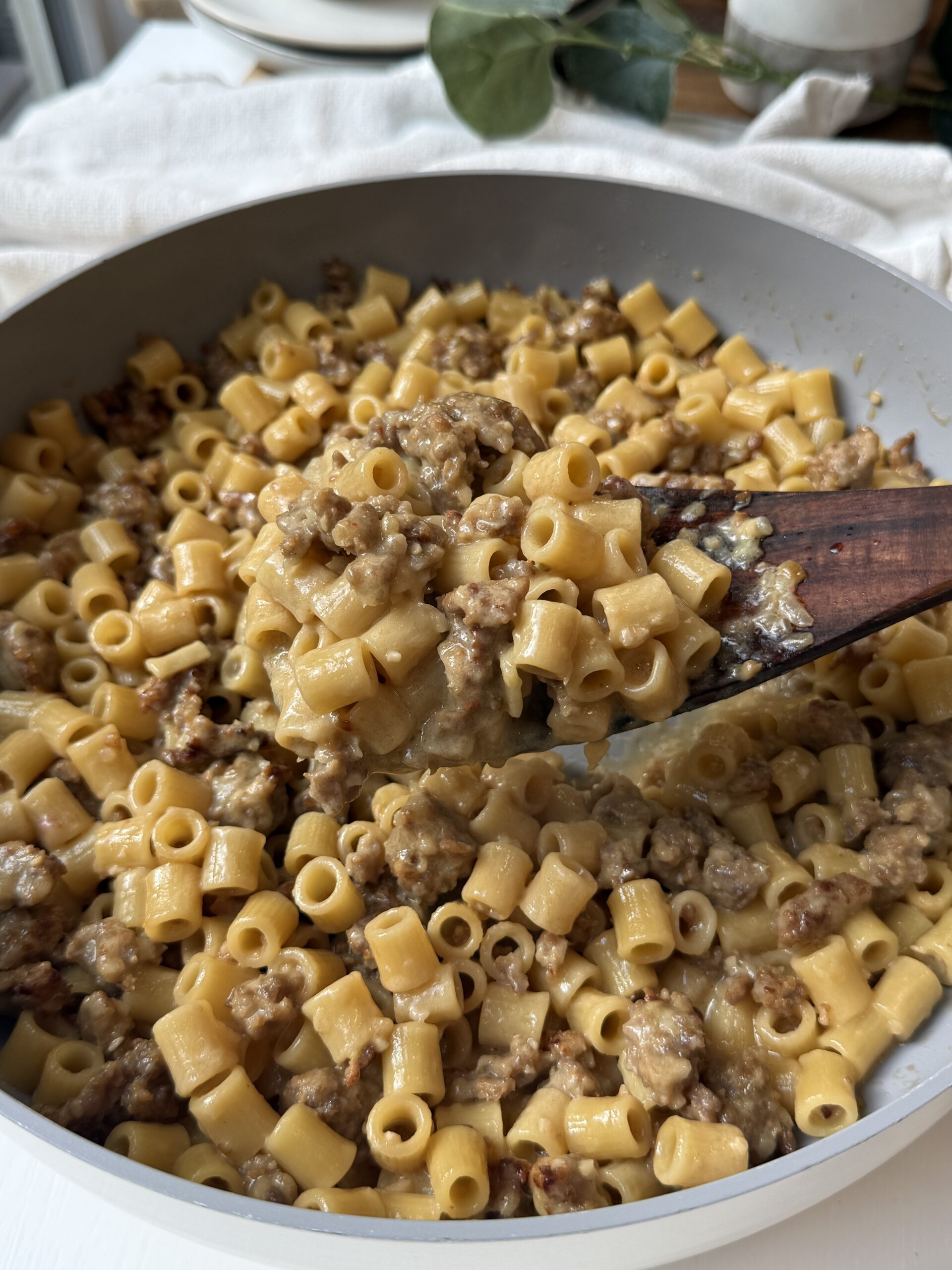 Creamy Italian sausage ditalini topped with freshly grated Parmesan and parsley in a skillet
