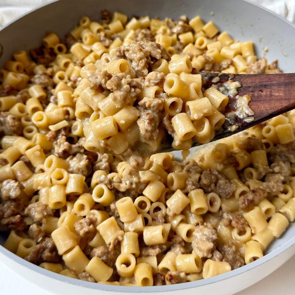 Creamy Italian sausage ditalini topped with freshly grated Parmesan and parsley in a skillet