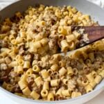 Creamy Italian sausage ditalini topped with freshly grated Parmesan and parsley in a skillet
