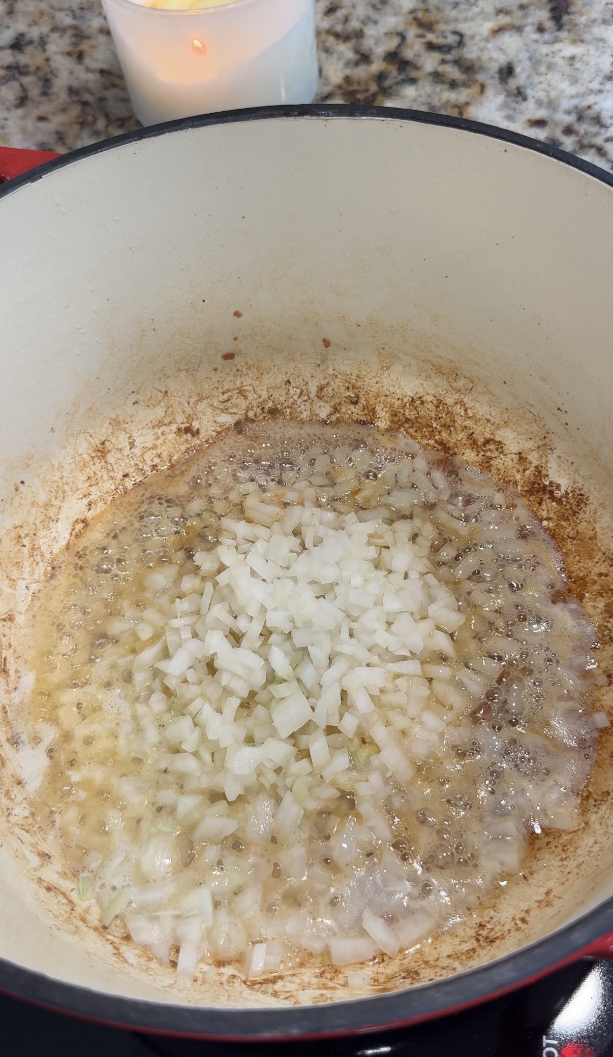 Diced onions cooking in a dutch oven