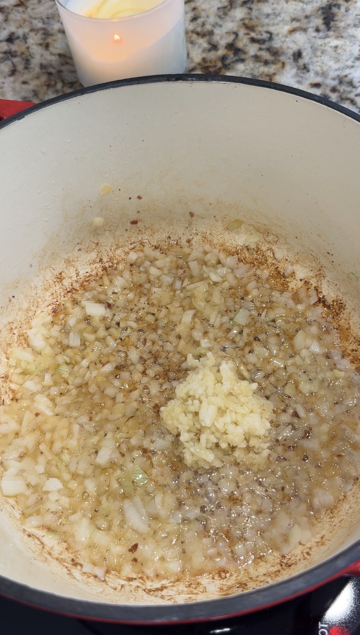 Diced onions and minced garlic cooking in a dutch oven