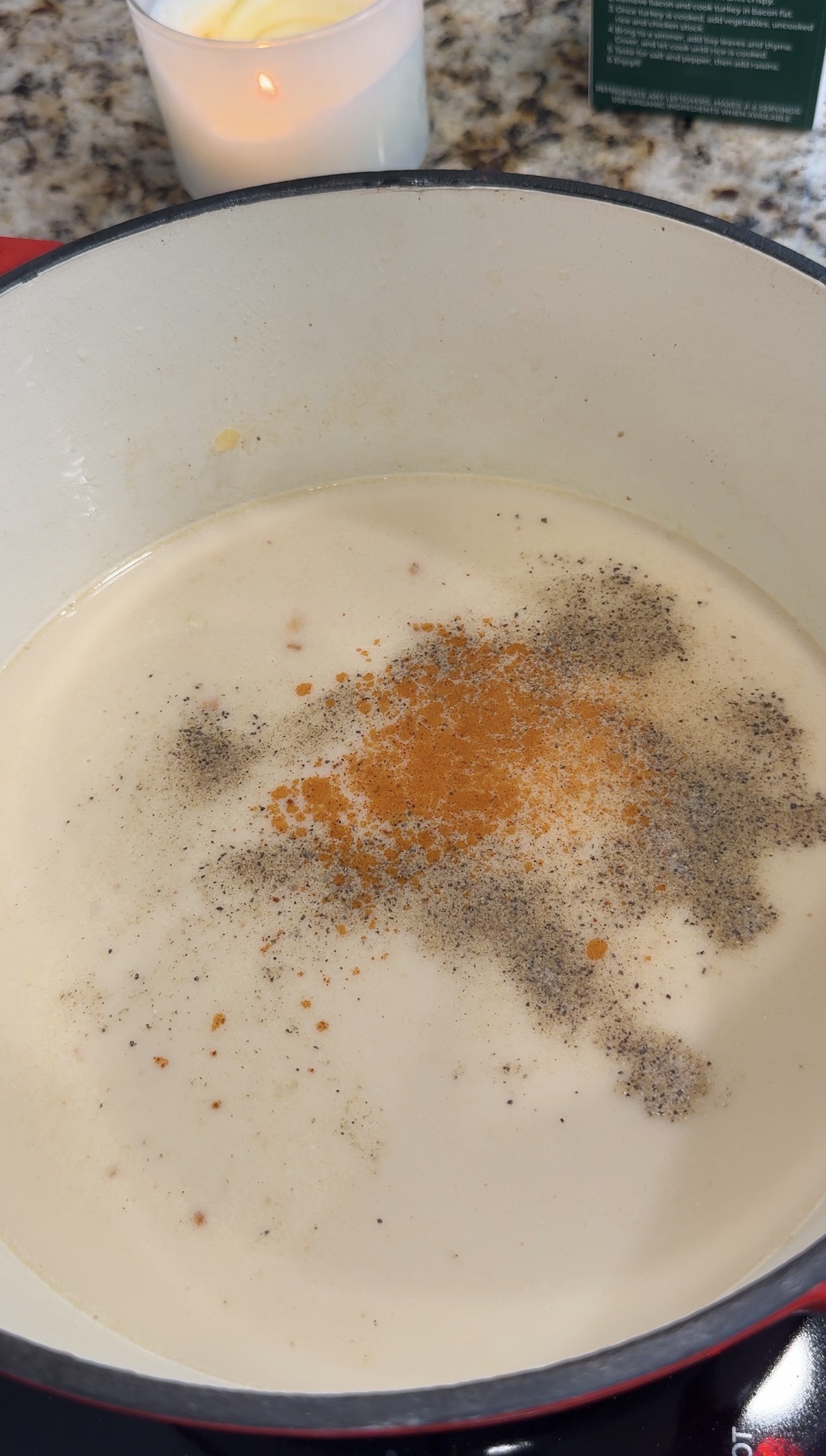 Ground black pepper and cayenne pepper in a dutch oven with the loaded potato soup