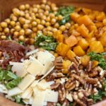 Harvest salad with roasted butternut squash, crispy chickpeas, kale, prosciutto, pecans, Parmesan, and lemon tahini dressing