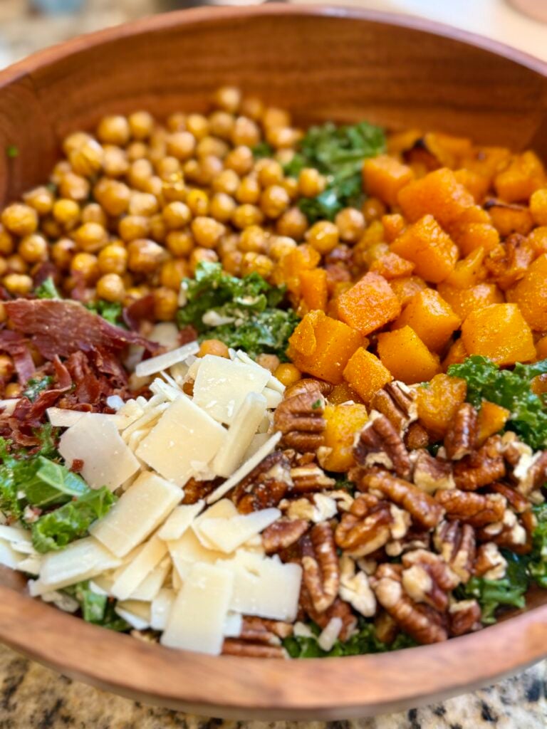 Harvest salad with roasted butternut squash, crispy chickpeas, kale, prosciutto, pecans, Parmesan, and lemon tahini dressing