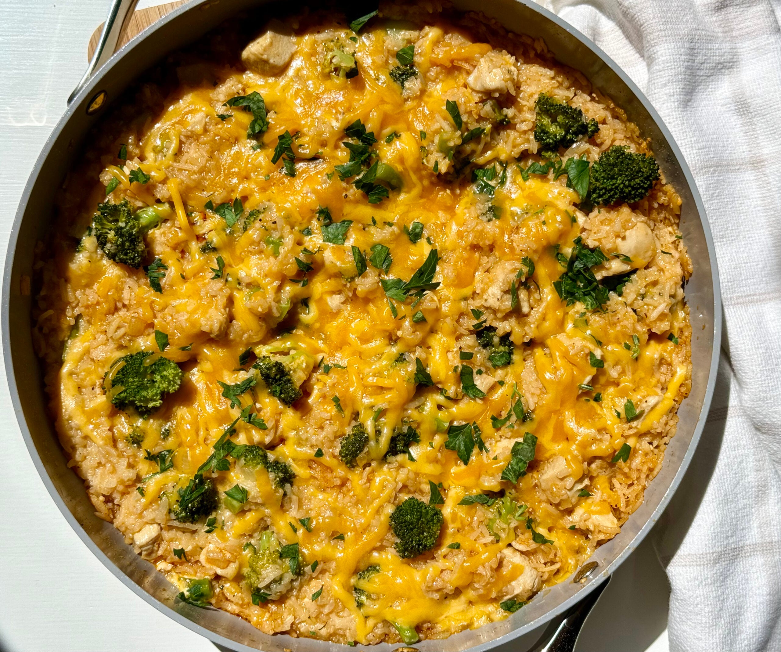 Healthy chicken broccoli rice casserole served up in a skillet.