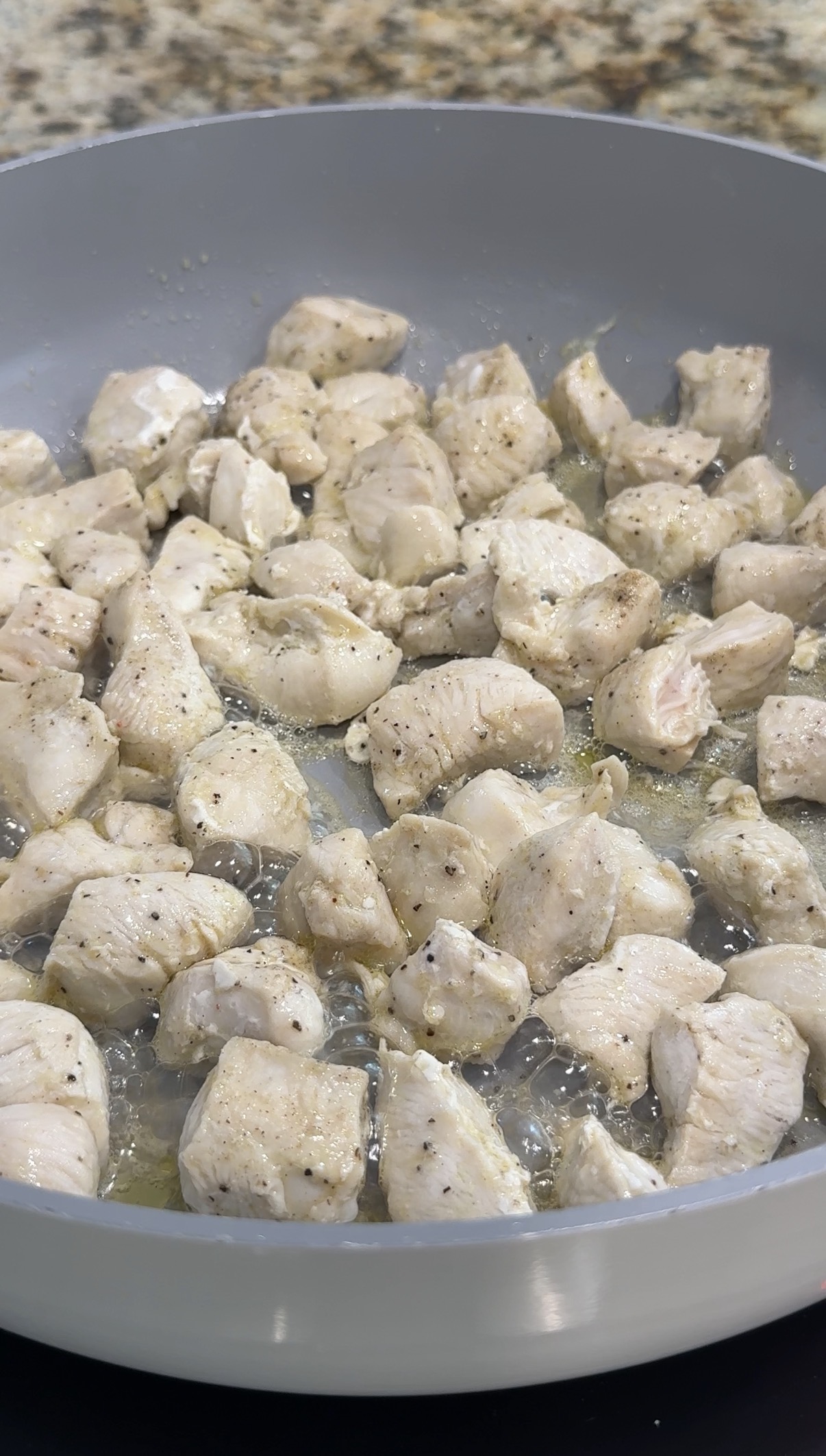 Chicken cooking in a skillet.