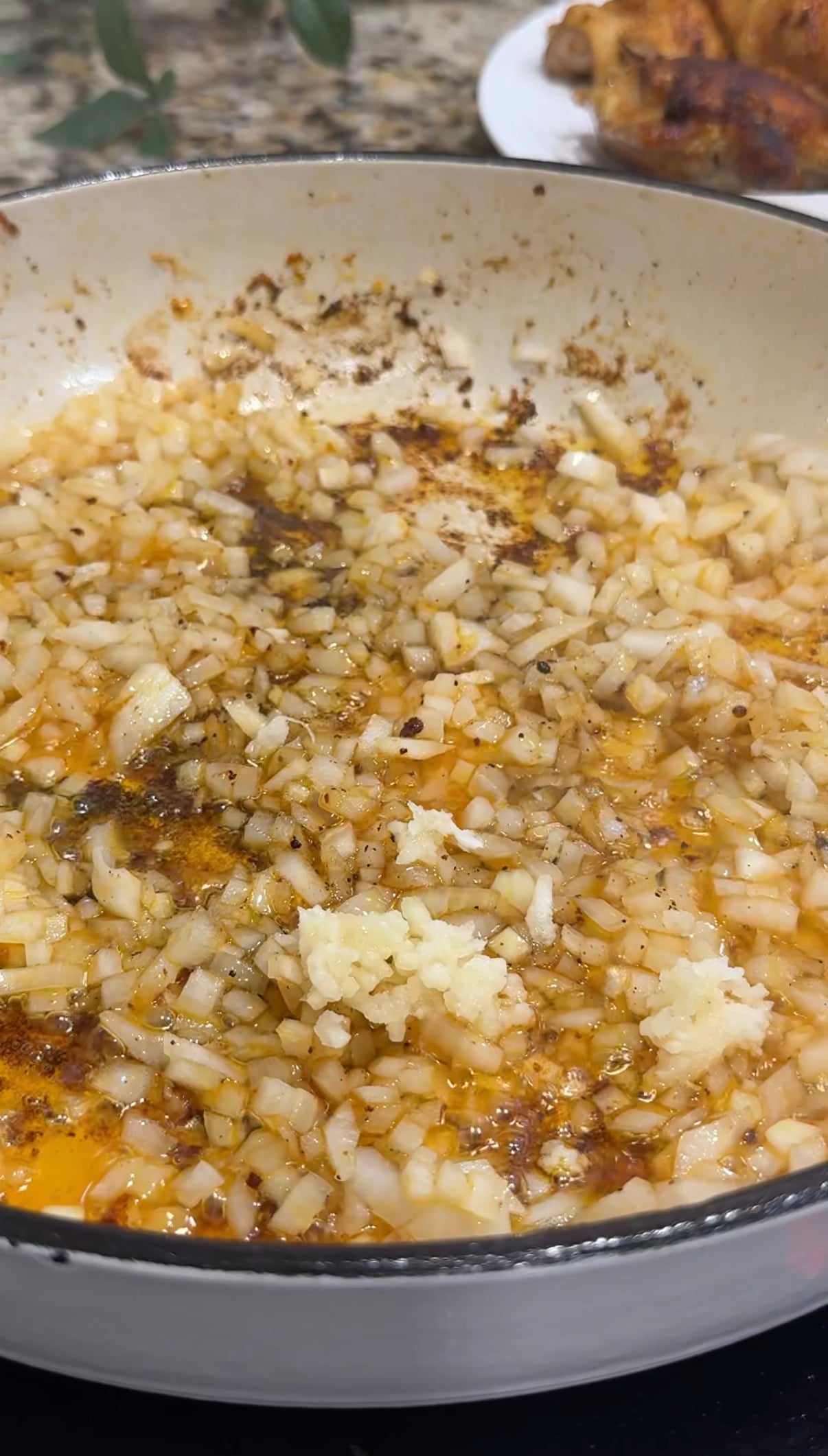 Onion and garlic sautéing in a pan