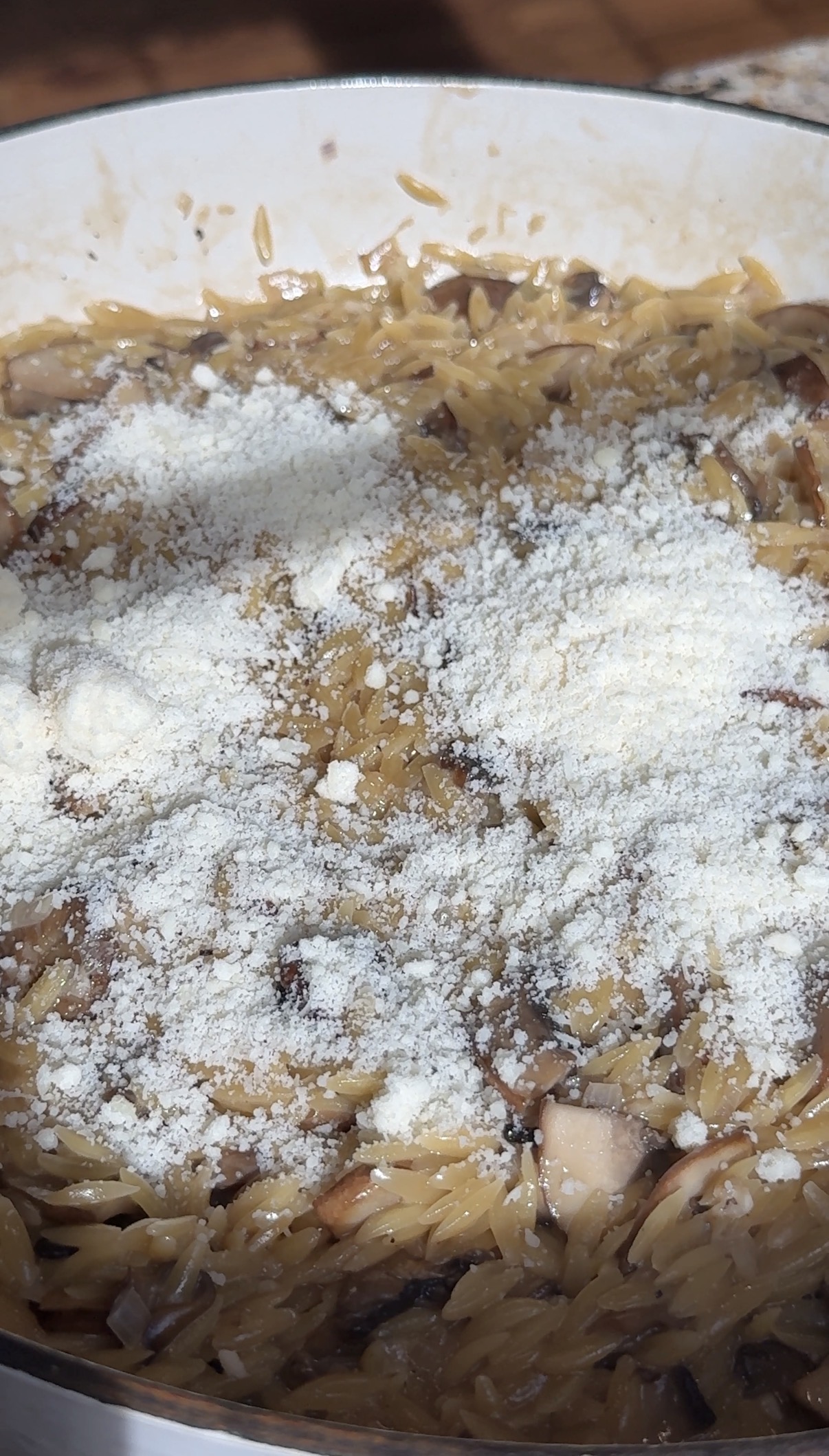 Freshly grated Parmesan cheese stirred into creamy mushroom orzo.